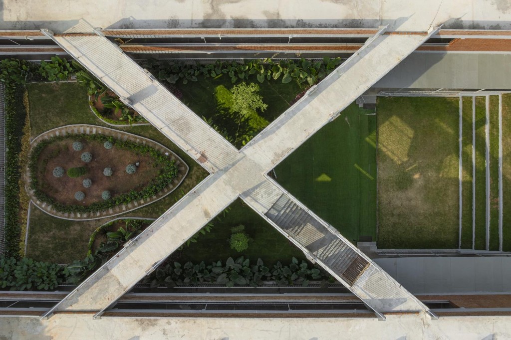 Aerial view of intersecting walkways forming an X over a landscaped courtyard, symbolizing matching payments to invoices