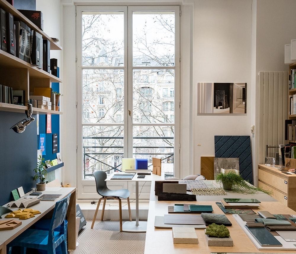 An independent professional at work in a design studio, representing the skill and value behind well-priced services
