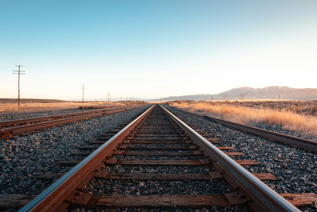 Railway tracks stretching toward the horizon, symbolizing an invoice's progression through its lifecycle