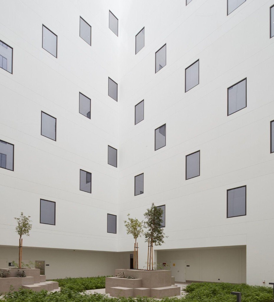 A minimal architectural courtyard with repeating geometric forms, suggesting structure and predictable, recurring billing